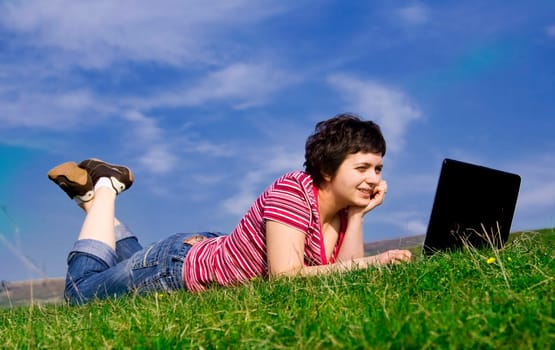Young casual woman working on laptop