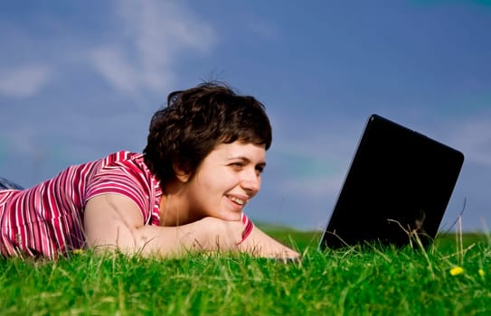 Young casual woman working on laptop