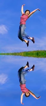 Young happy woman jumping high against b