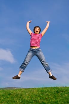 Young happy woman jumping high against b
