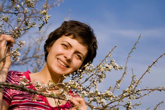 Beautiful young woman amongst spring blo