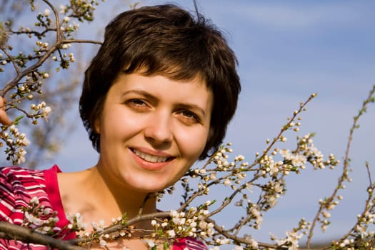Beautiful young woman amongst spring blo