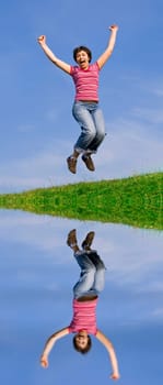 Young happy woman jumping high against b