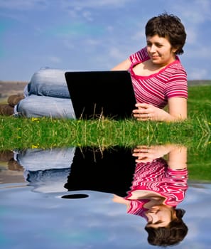 Young casual woman working on laptop out