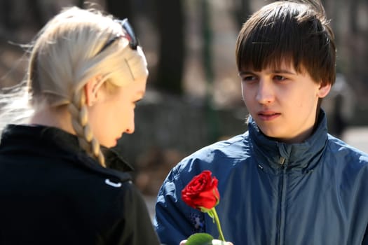 Young man giving rose