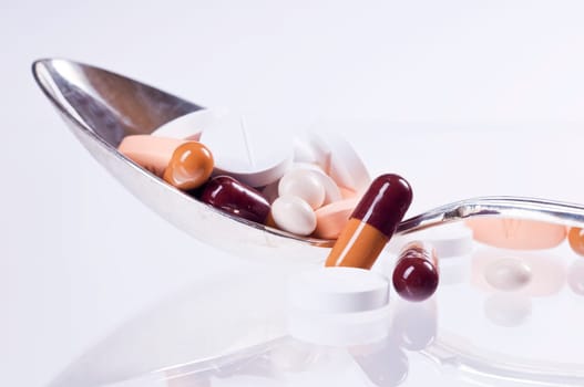 various tablets on spoons