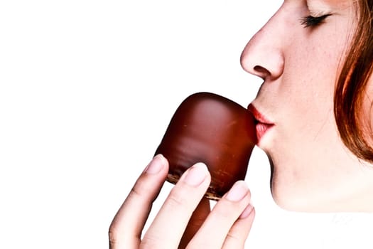 Young woman kisses a chocolate kiss