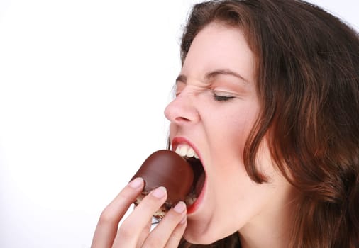 Young woman bites into a chocolate kiss