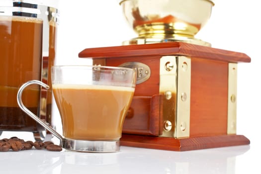 Cup, grinder, coffee pot and beans