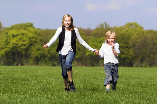 Siblings romping outdoors
