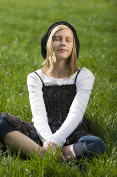 Blond girl lying on a meadow
