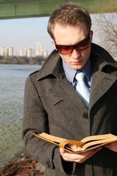 Businessman reads outdoors