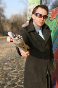 Man pointing with newspaper