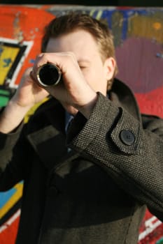 Private detective looking through telescope