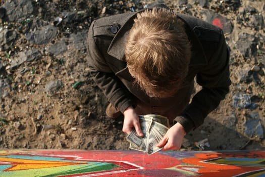 Man counting money outdoors