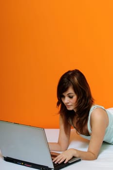 Girl with laptop in bed