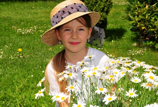 Child with daisies and hat