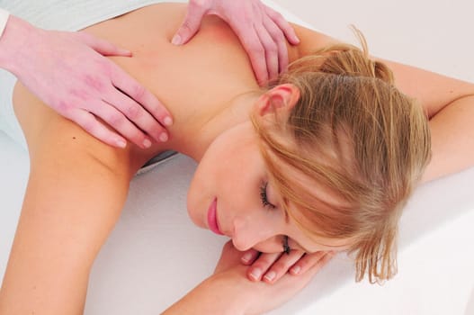 Blonde woman receives a relaxing massage