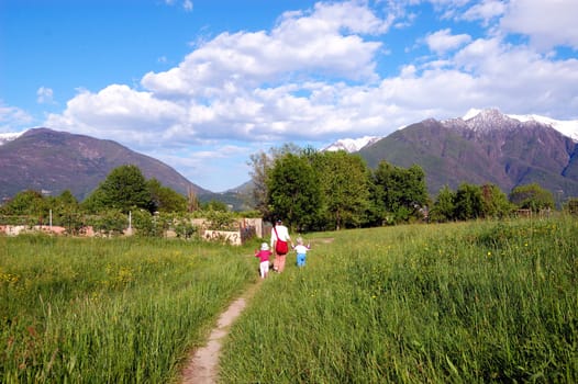 Family Walking in spring field