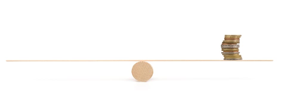 scale with coins on white background