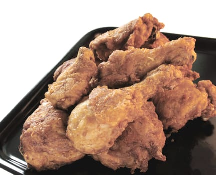 fried chicken on a black platter