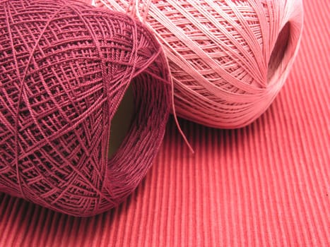 Wool ball on red background