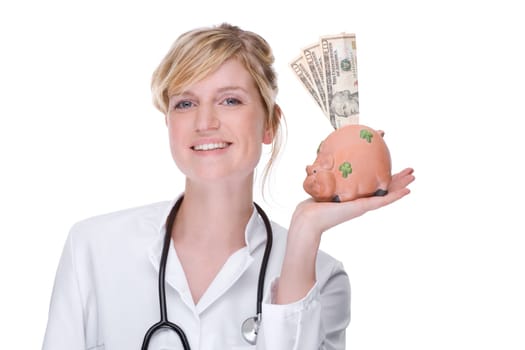 Young female doctor with piggy bank
