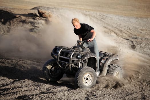 teenager riding quad - four wheeler ATV