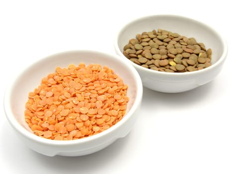 Two porcelain bowls with red lentils and plate lentils