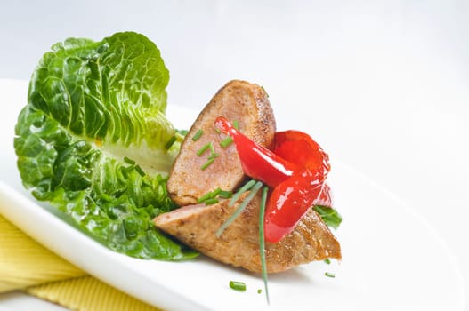 Pork tenderloin,fried on salad with chives