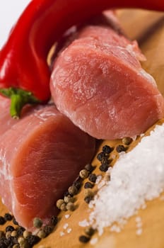 Raw pork tenderloin on wooden board