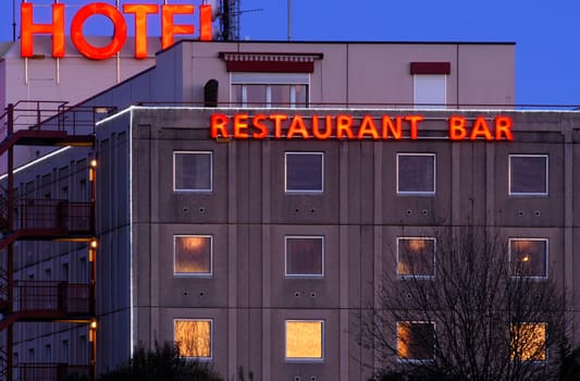 Hotel with neon sign in the evening
