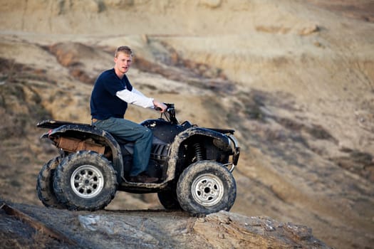 teen on quad ATV in the hills