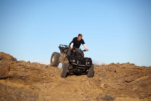 teen on ATV quad in the hills