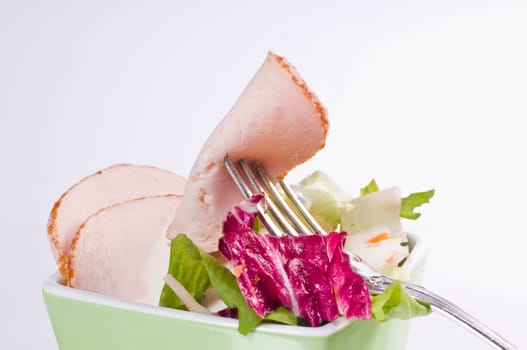 Mixed salad in green bowl