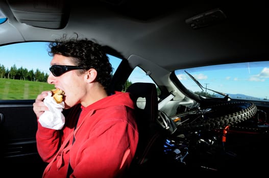 Man driving while eating from a bag