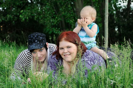 three people in the grass