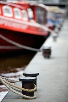 boats docked in harbor bollards