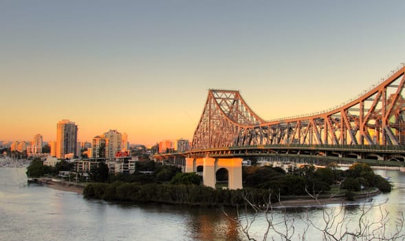 The iconic Story Bridge spanning the Brisbane River in Brisbane Australia at sunrise.