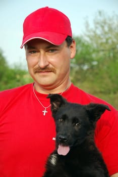 Man with German Shepherd puppy