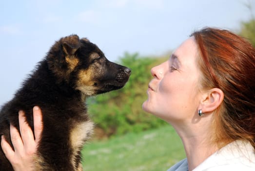 Woman with German Shepherd puppy