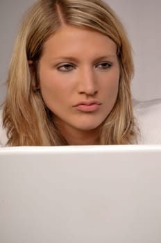Closeup Of A Serious Blond Woman With Laptop