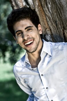 Happy Brunette Man Near Tree