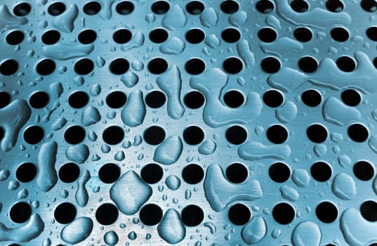 Rain drops on a metal grate