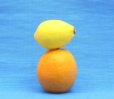 Lemon on orange stacked on blue background