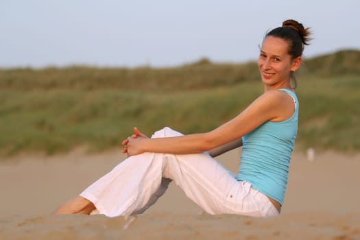 Fitness woman on sand beach