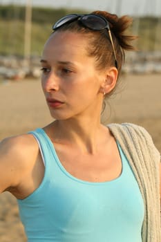 Woman with towel by sunset