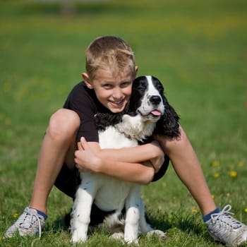 A boy poses with his puppy