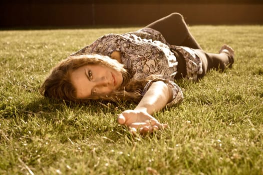 Beautiful Blonde Girl Lying On Grass