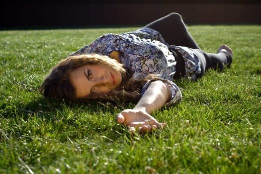 Cute Blond Girl Lying Back On Grass